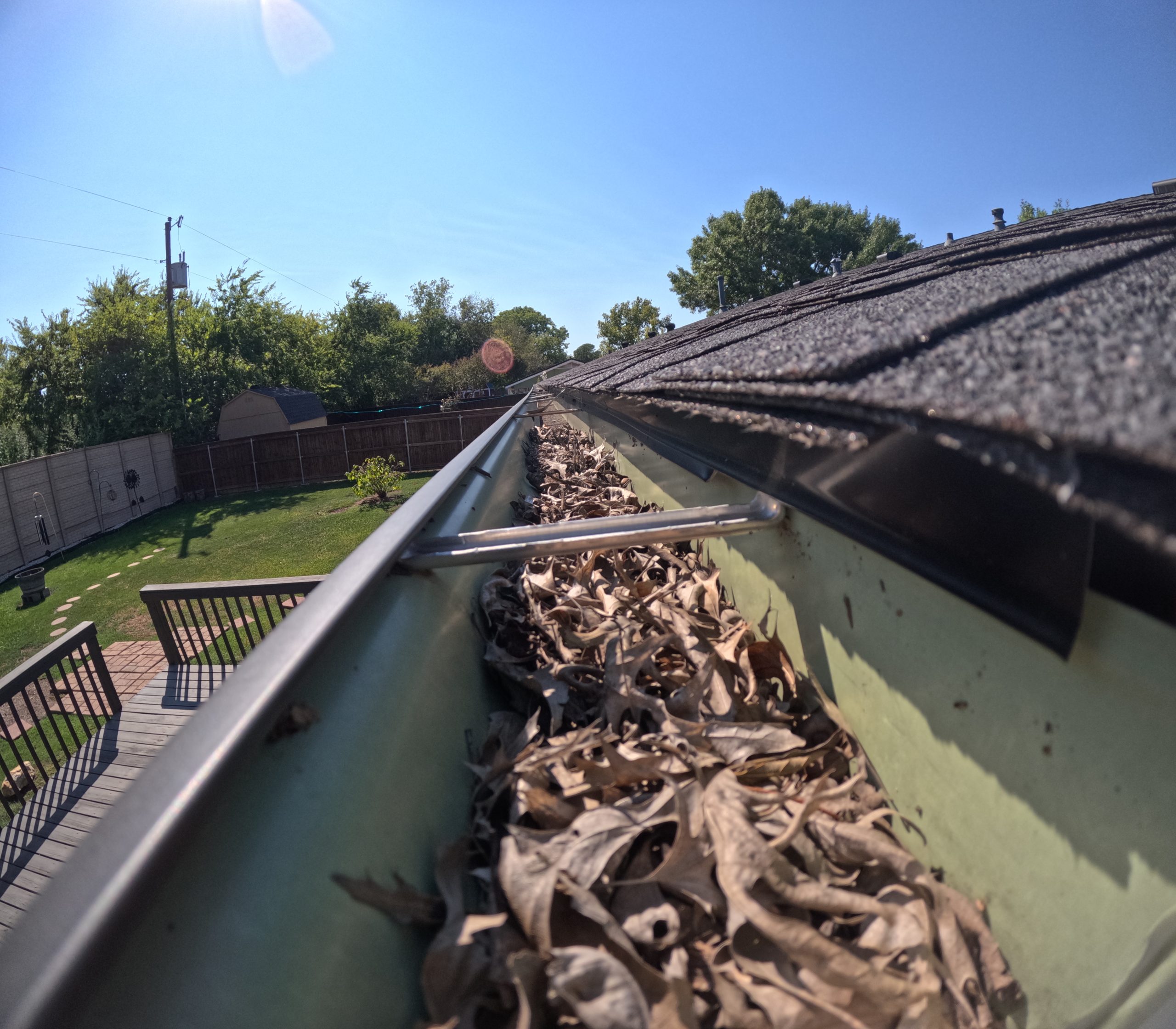 Gutter filled with leaves before cleaning